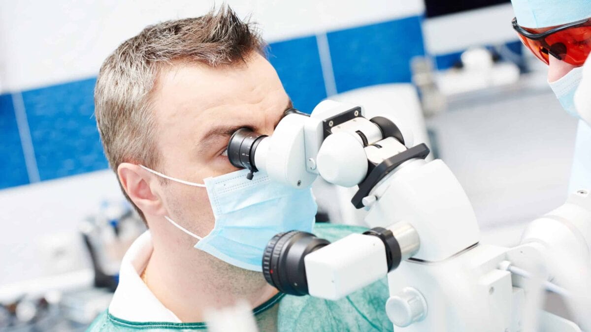 dentist using a microscope