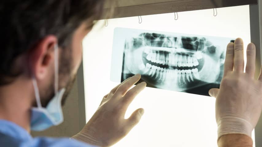 Endodontist looking at a dental x-ray.