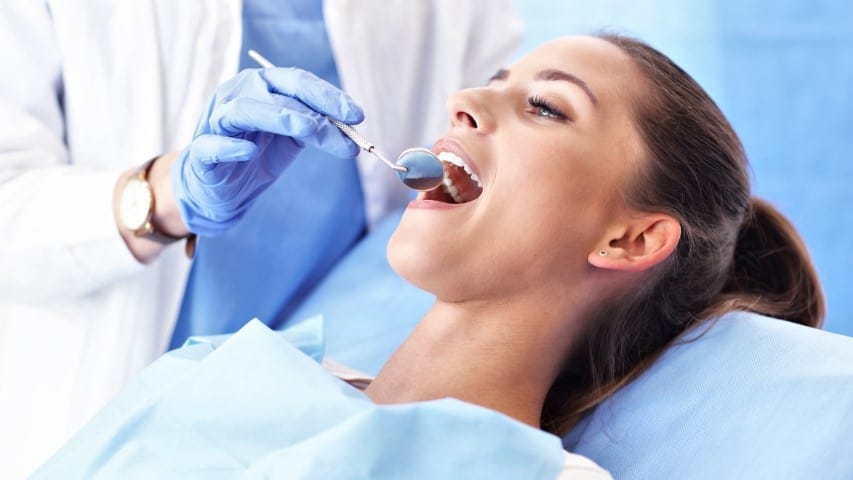 Adult woman having a visit at the dentist's