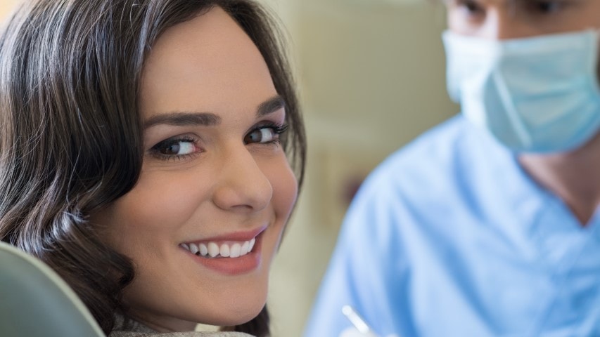 Smiling woman in dental office.