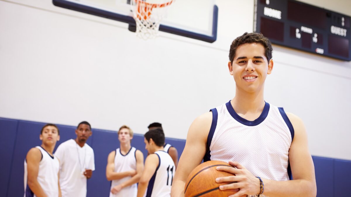 Smiling teenager holding a basketball
